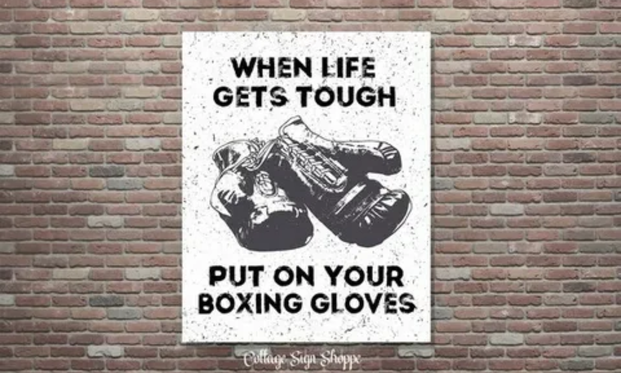 Boxer training in the ring with Inspirational Boxing Quotes for daily motivation
